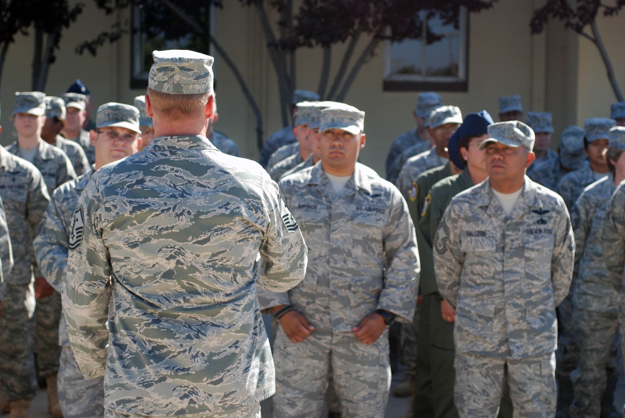 An Airman speaks to the members of a formation in front of the 452nd Air Mobility Wing headquarters building at March Air Reserve Base, Calif., Aug. 21, 2010. (U.S. Air Force photo by Staff Sgt. Kevin Chandler)