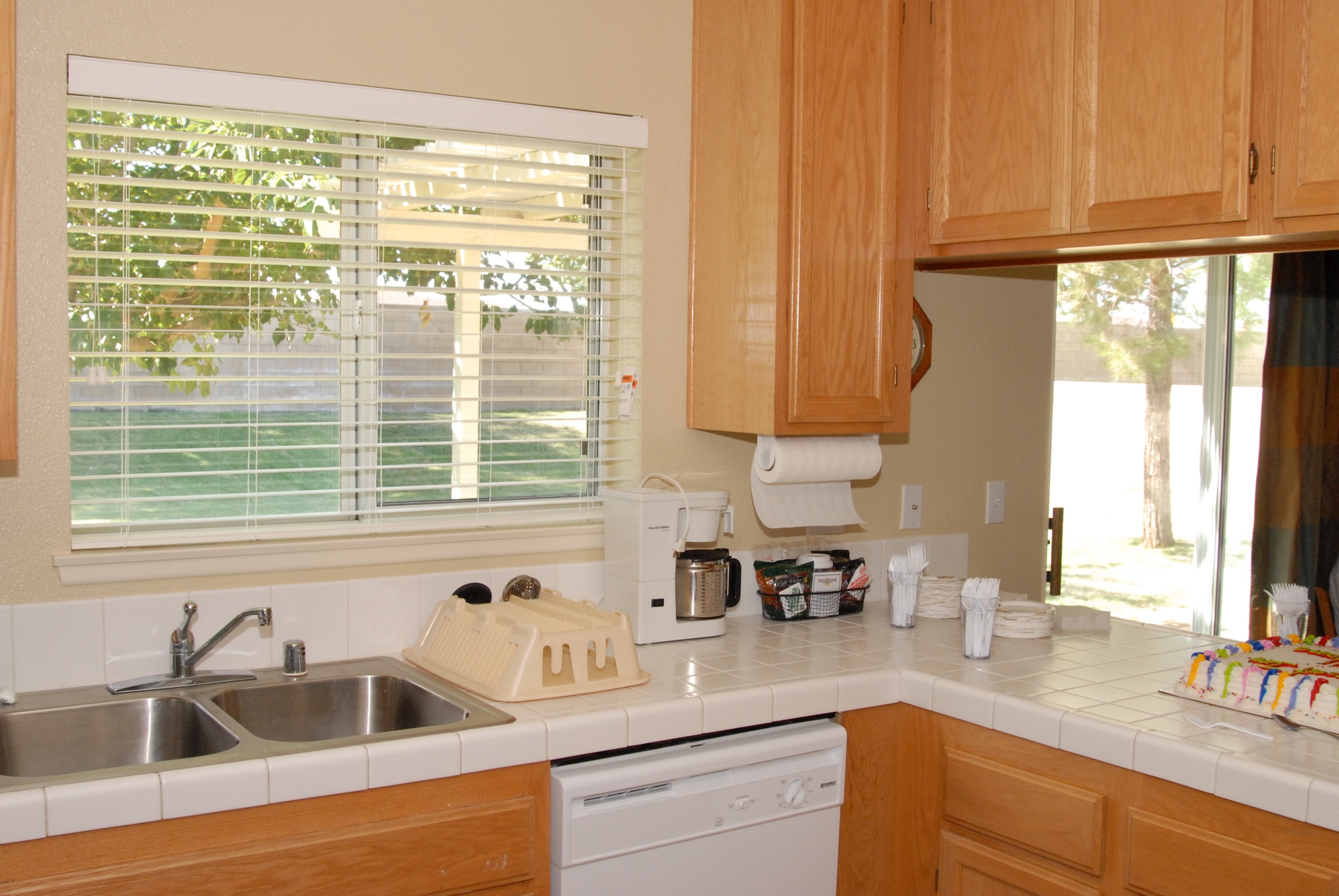 A cozy kitchen with a picture window offers a view of the beautifully landscaped backyard at the newly opened Temporary Lodging Facility. Tenants are able to keep sight of their children while at play. (Air Force photo by Stephen K. Robinson)
