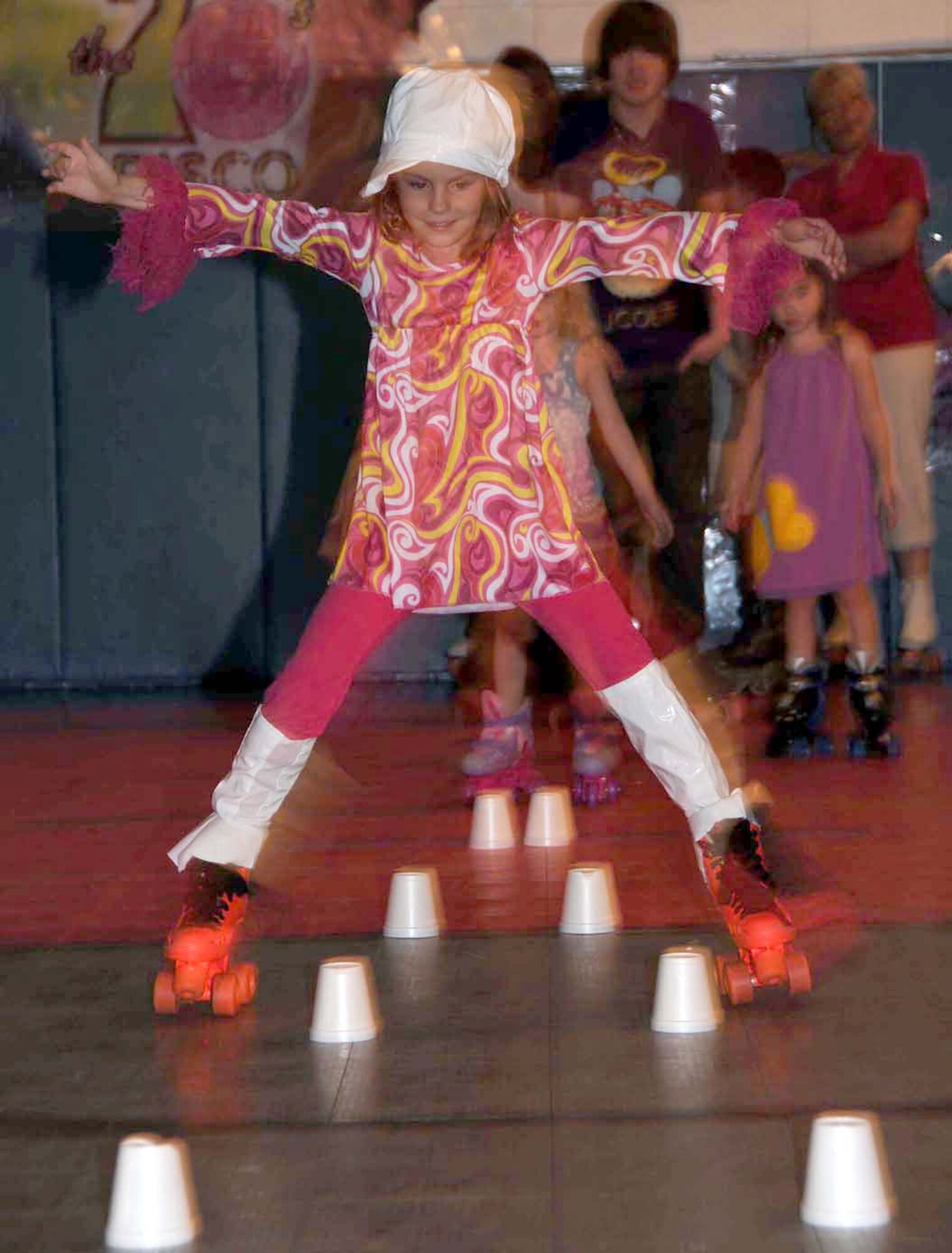 Eight-year-old Melanie Gilliam, daughter of Master Sgt. Lancer and Melissa Gilliam, 338th Training Squadron, shows her skating skills at a skating party for families of deployed Airmen, Aug. 13 at the youth center. Melanie’s dad is deployed to  Southwest Asia.  (U.S. Air Force photo by Kemberly Groue)