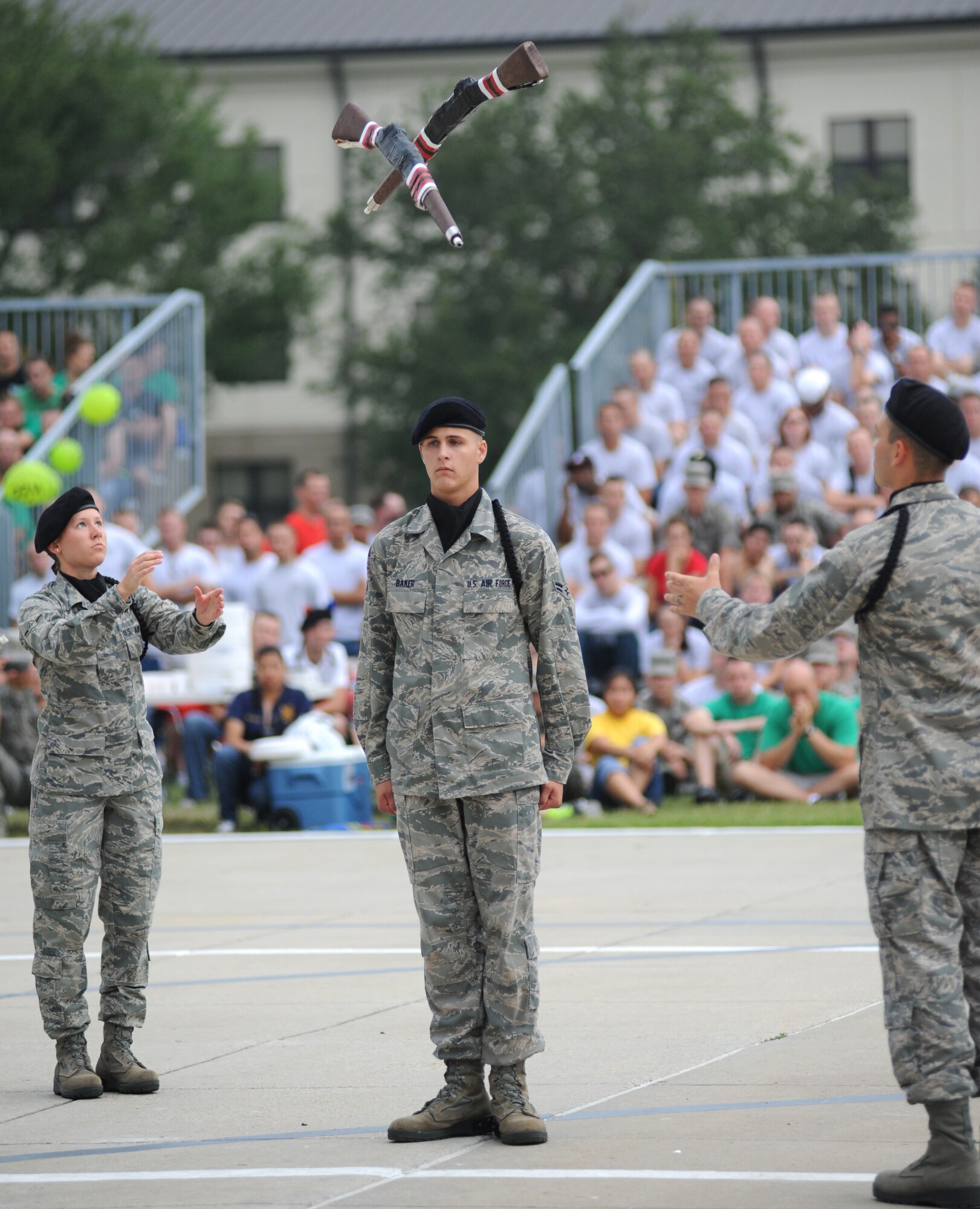 From left, Airman Erica Whitney, Airman 1st Class Anthony Baker and Airman Basic
David Lowe compete with the 335th Training Squadron drill down freestyle drill team August 19. Baker was the drill master for the team.  (U.S. Air Force photo by Kemberly Groue)