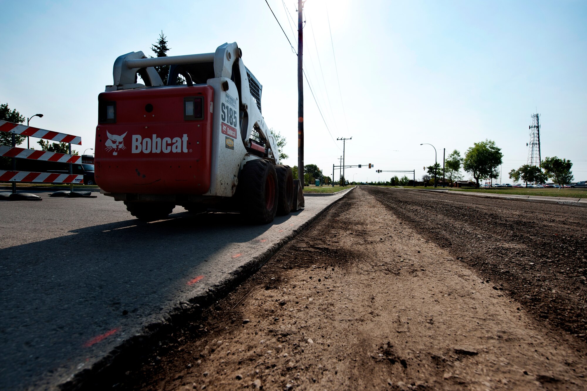 MINOT AIR FORCE BASE, N.D. – Contractors repair pot holes and reconstruct the road along Missile Avenue to the front gate, resulting in detours through base housing, here Aug. 23. This project will provide a more winter ready road surface by reducing the risk of splitting caused by freezing weather conditions. (U.S. Air Force Photo/ Airman 1st Class Stephanie Ashley) (RELEASED)