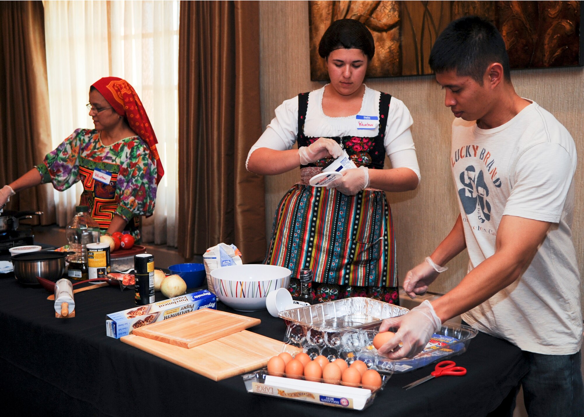 MINOT AIR FORCE BASE, N.D. -- Minot Airmen prepare a variety of international foods at the Jimmy Doolittle Center Aug. 19. For Diversity Day, Airmen prepared a combination of Asian Pacific, Hispanic, and European cuisine. The event ran for approximately five hours and included a variety of multi-cultural booths, cooking, dancing, singing, and poetry. (U.S. Air Force photo/Senior Airman Ashley N. Avecilla)(RELEASED)