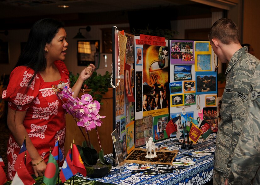 MINOT AIR FORCE BASE, N.D. – Tech. Sgt. Jeannie Ruzek (left), 5th Bomb Wing emergency actions controller, speaks with Minot Airmen at the Jimmy Doolittle Center Aug. 19. Ruzek ran the Diversity Day Asian-Pacific heritage booth. The event ran for approximately five hours and included a variety of multi-cultural booths, cooking, dancing, singing, and poetry. (U.S. Air Force photo/Senior Airman Ashley N. Avecilla)(RELEASED)