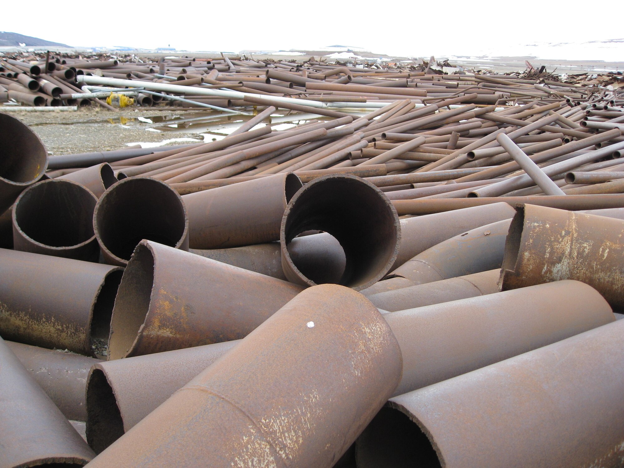 Piping, fuel tanks and other scrap metal weighing more than 15,000 tons had accumulated at Thule AB during the last 15 years. An increase in scrap metal prices allowed a recycling project that netted the base a check for more than $1 million, as a recycling company came in and hauled the scrap off the island. (U.S. Air Force photo/Todd DeGarmo)
