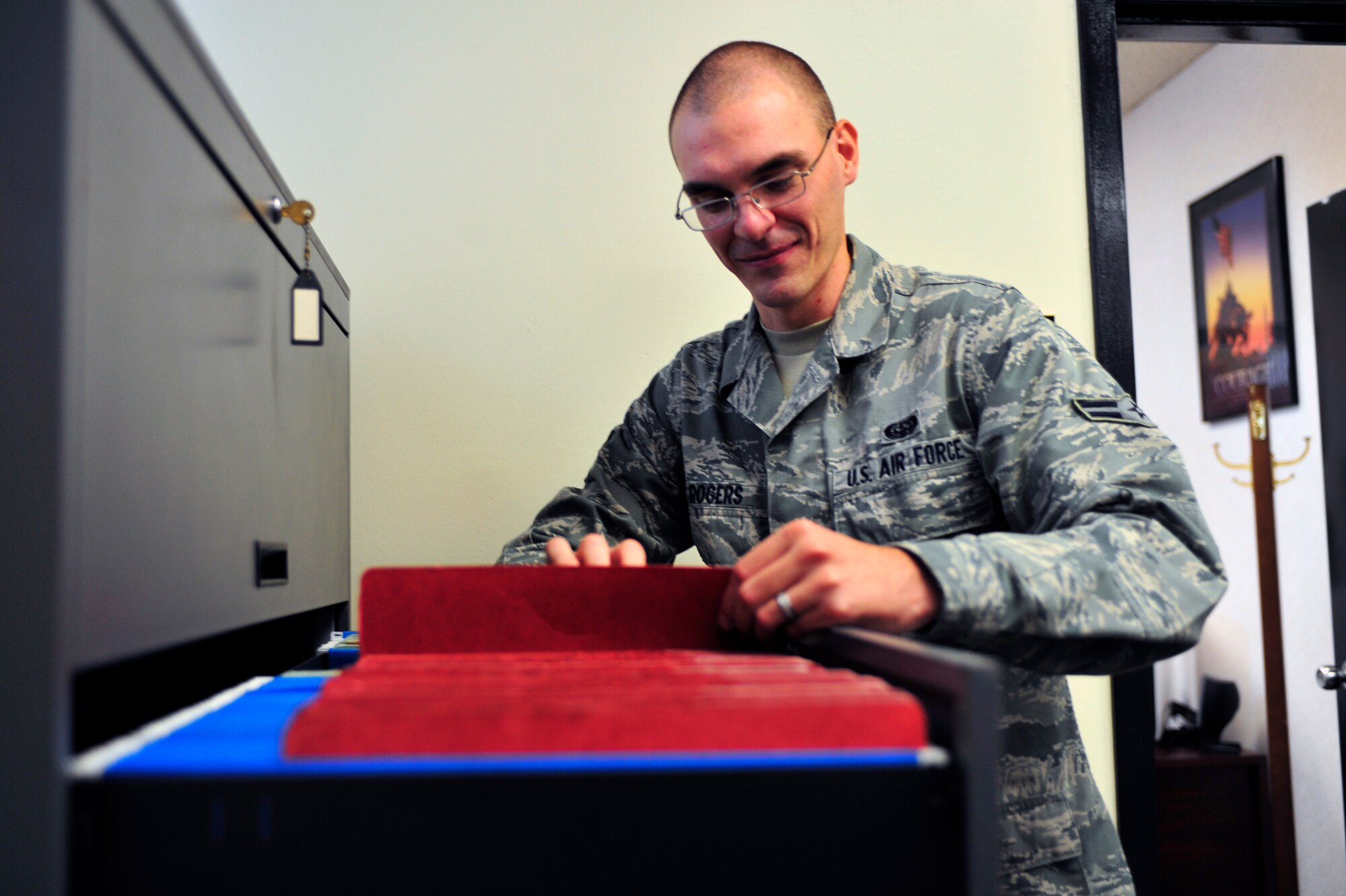 U.S. Air Force Airman 1st Class Vernon Rogers, 20th Communications Squadron cyber security, looks through some files for Privacy Act information at the 20th Communcations Squadron at Shaw Air Force Base, S.C. Aug. 22, 2011. Rogers is the Warrior of the Week for the week of Aug. 22 through 26. (U.S. Air Force photo/Airman 1st Class Daniel Phelps) (Released)