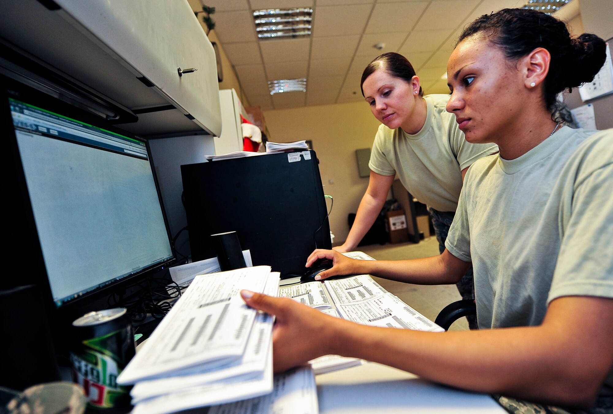 Staff Sgt. Lindsey Hollingsworth, 379th Expeditionary Logistics Readiness Squadron warehouse supervisor, helps Airman 1st Class Natasha Fernandez, 379th ELRS warehouse technician, input Air Force Forms 1348 into the Enterprise Solution-Supply program, Aug. 23, at an undisclosed location in Southwest Asia.  The Enterprise Solution-Supply online tool gives logisticians the ability to find aircraft parts stored in any of the more than 300 Air Force depot- or base-level supply accounts with a single query that processes in seconds.  Hollingsworth is from Fuquay-Varina, N.C., and is deployed from the 4th Logistics Readiness Squadron, Seymour Johnson AFB, N.C.  Fernandez is from Miami, Fla., and is deployed from the 87th Logistics Readiness Squadron, Joint Base McGuire-Dix-Lakehurst, N.J.   (U.S. Air Force photo/Senior Airman Paul Labbe)