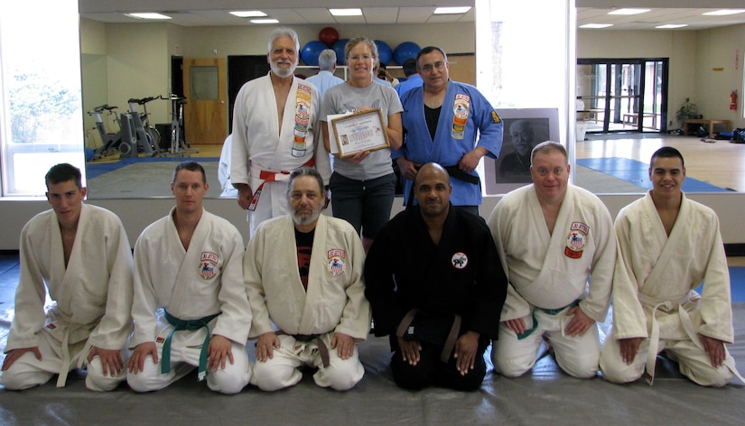 The Samurai Judo Association recently presented Nancy Haynsworth (center) with a Certificate of Appreciation to show their gratitude for her efforts in making the Morale Welfare and Recreation Judo and Jujitsu classes a success. The free classes, held at the Joint Bae Charleston - Weapons Station gym, are available to all active duty personnel and their adult family members. Haynsworth is a physcial fitness trainer at JB CHS - WS MWR. (courtesy photo)