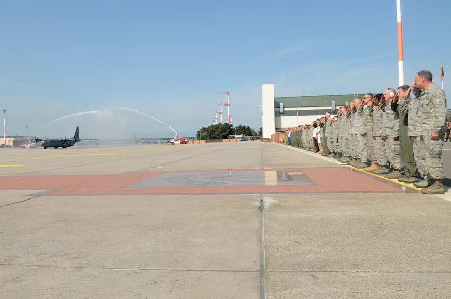 Members of the 86th Airlift Wing salute Brig. Gen. Mark Dillon, 86th Airlift Wing commander, as he pilots a C-130J Super Hercules during his final flight, Ramstein Air Base, Germany, Aug. 24, 2011. Brig. Gen. Dillon is a command pilot with more than 3,500 flying hours in the KC-10, C-5, T-38, C-17, C-130J and KC-135. (U.S. Air Force photo by Senior Airman Brittany Perry) 