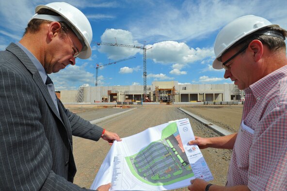 SPANGDAHLEM AIR BASE, Germany – Udo Stuermer, left, 52nd Civil Engineer Squadron programs flight chief, and Rolf Neuhaus, 52nd CES project engineer, review the blueprints of the new Exchange here Aug. 17. Some of the planned amenities include a food court, barber shop, beauty salon, military clothing sales, concessionaire stands and a new retail store. The new structure will be a total of 107,316 square feet and will replace the current 15,446 square foot Exchange. Contractors began construction in October 2010, and the completion is scheduled for summer 2012. (U.S Air Force photo/Airman 1st Class Dillon Davis)