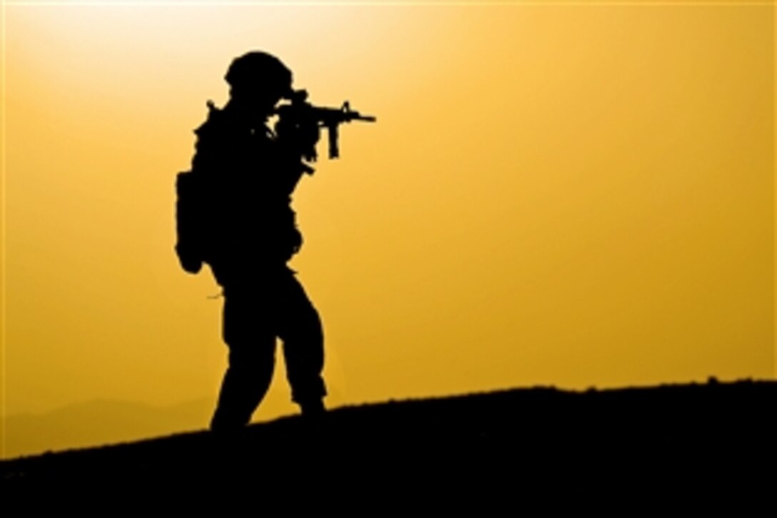 U.S. Army Sgt. 1st Class Robert Russell uses his weapon's scope to secure an area during a bridge inspection in Zabul province, Afghanistan, Aug. 22, 2011. Russell is a platoon sergeant assigned to the Provincial Reconstruction Team Zabul's security force.