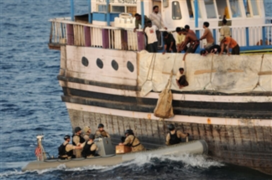 Crewmembers aboard the Al Habib, a Sri Lankan-flagged cargo vessel, hoist a bag of supplies from a visit, board, search and seizure team in a rigid hull inflatable boat in the Gulf of Aden on Aug. 13, 2011.  The Navy team and a Coast Guard advanced interdiction team are deployed from the guided missile destroyer USS Mitscher (DDG 57) in the Gulf of Aden.  