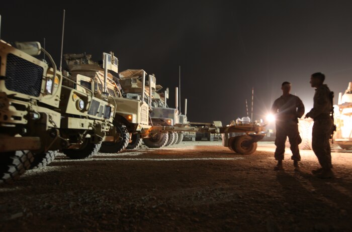 Marines with Bravo Company, Combat Logistics Battalion 6, 2nd Marine Logistics Group (Forward), spend a few moments discussing the night’s mission after performing preventive maintenance checks on their respective tactical vehicles aboard Camp Leatherneck, Afghanistan, Aug. 26. The convoy travelled to several bases in the Helmand’s Sangin district to resupply troops based there and also backhauled any damaged or excess gear they came across in preparation for the imminent realignment and retrograde of troops in Afghanistan. (U.S. Marine Corps photo by Sgt. Justin J. Shemanski)
