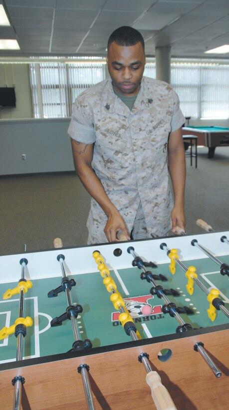 Sgt. Michael C. Barnes, shipping noncommissioned officer, Critical Assets Rapid Distribution Facility, plays a game of foosball at the Single Marine Recreation Center, Aug. 25.