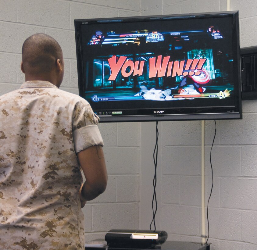 Sgt. Michael C. Barnes, shipping noncommissioned officer, Critical Assets Rapid Distribution Facility, beats his opponent while playing the Xbox at the Single Marine Recreation Center, Aug. 25.