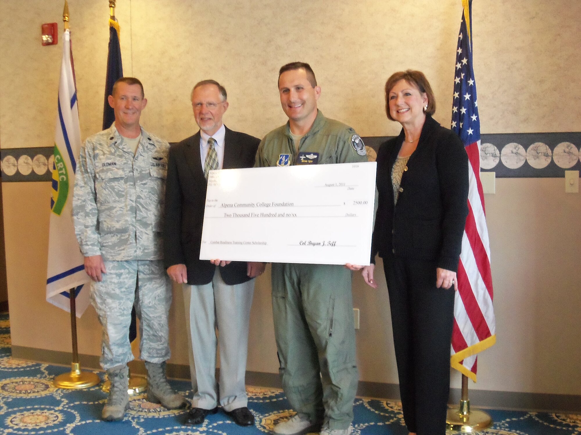 Col Bryan Teff and Lt Col Bret Oldman present a $2500 check to Alpena Community College for the newly sponsored Alpena CRTC Scholarship.