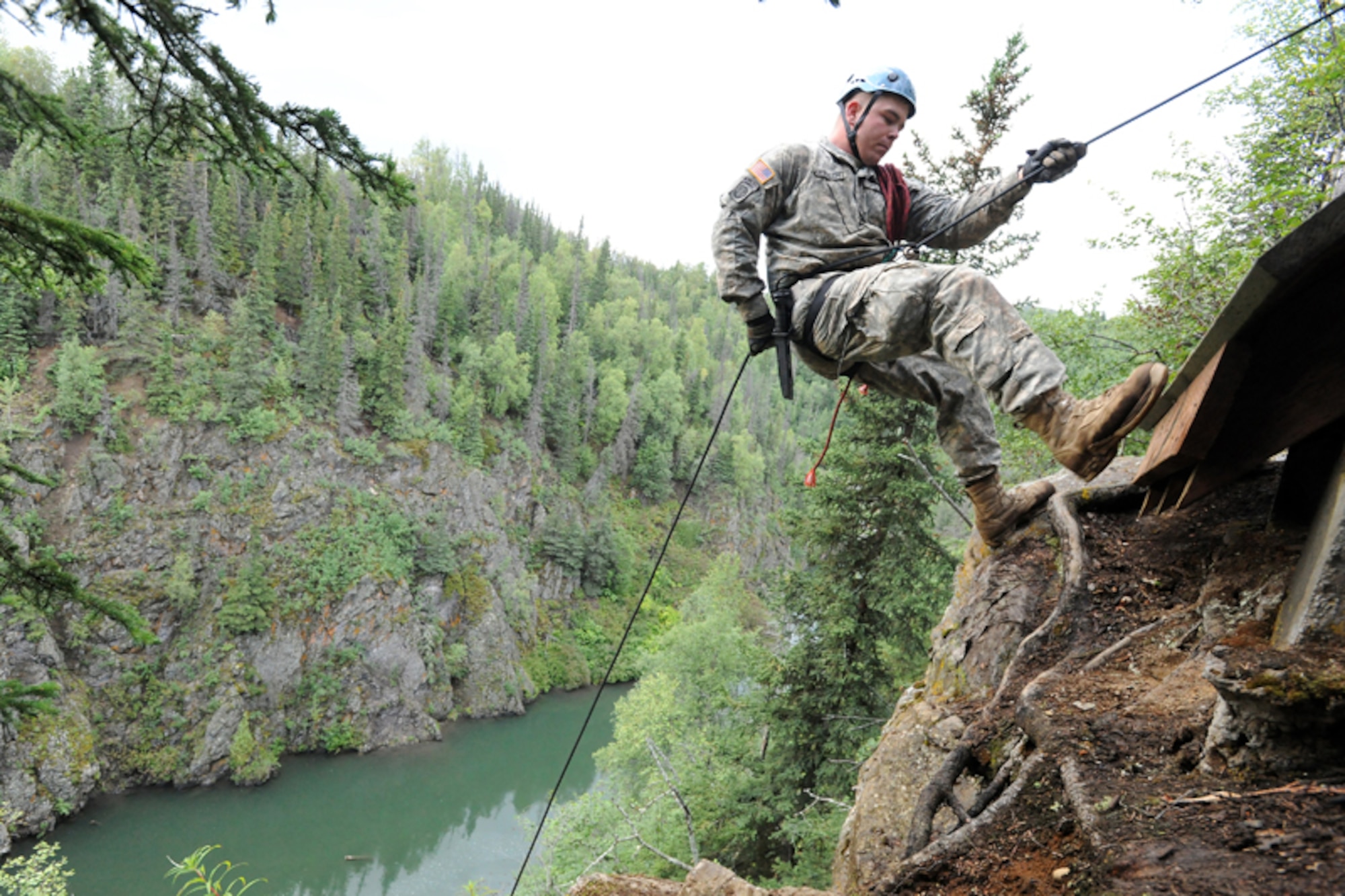 Sgt. Philip Rupprecht of Toledo, Ohio, rappels down a cliff overlooking Ship Creek as Soldiers of 6th Engineer Battalion (Combat) (Airborne), compete in the Order of the Arctic Sapper competition. Six teams of about 10 Soldiers competed in mountain climbing, rappelling, river crossing and several other combat engineer events to be inducted into the Order of the Arctic Sapper. (U.S. Air Force photo/Justin Connaher)
