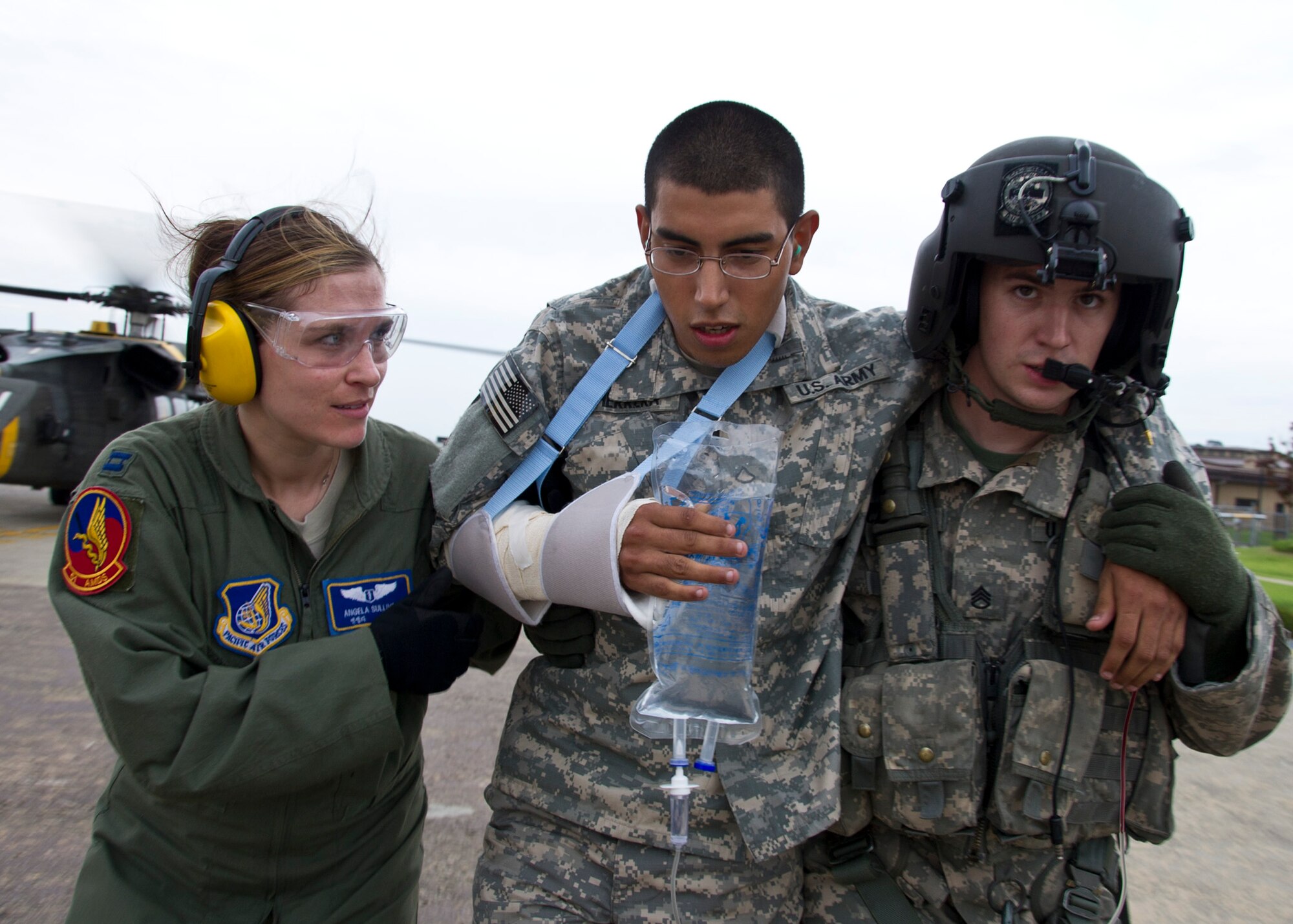 Capt. Angela Sullivan, 51st Medical Group flight surgeon, and Staff Sgt. Justin Cauthen, Charlie Company 3rd General Support Aviation Battalion, 2nd Aviation Regiment, 2nd Combat Aviation Brigade, 2nd Infantry Division flight medic, help an injured patient to the ambulance after being retrieved from a UH-60 Black Hawk during Dragon Lift, Aug. 24, 2011. During Dragon Lift, Airmen from the 51st MDG were broken down into five teams; field response, patient administration, minimal/delayed, medical command center and manpower. The teams were evaluated on the ability to transport a patient safely using proper safety techniques. (U.S. Air Force photo/Senior Airman Adam Grant)