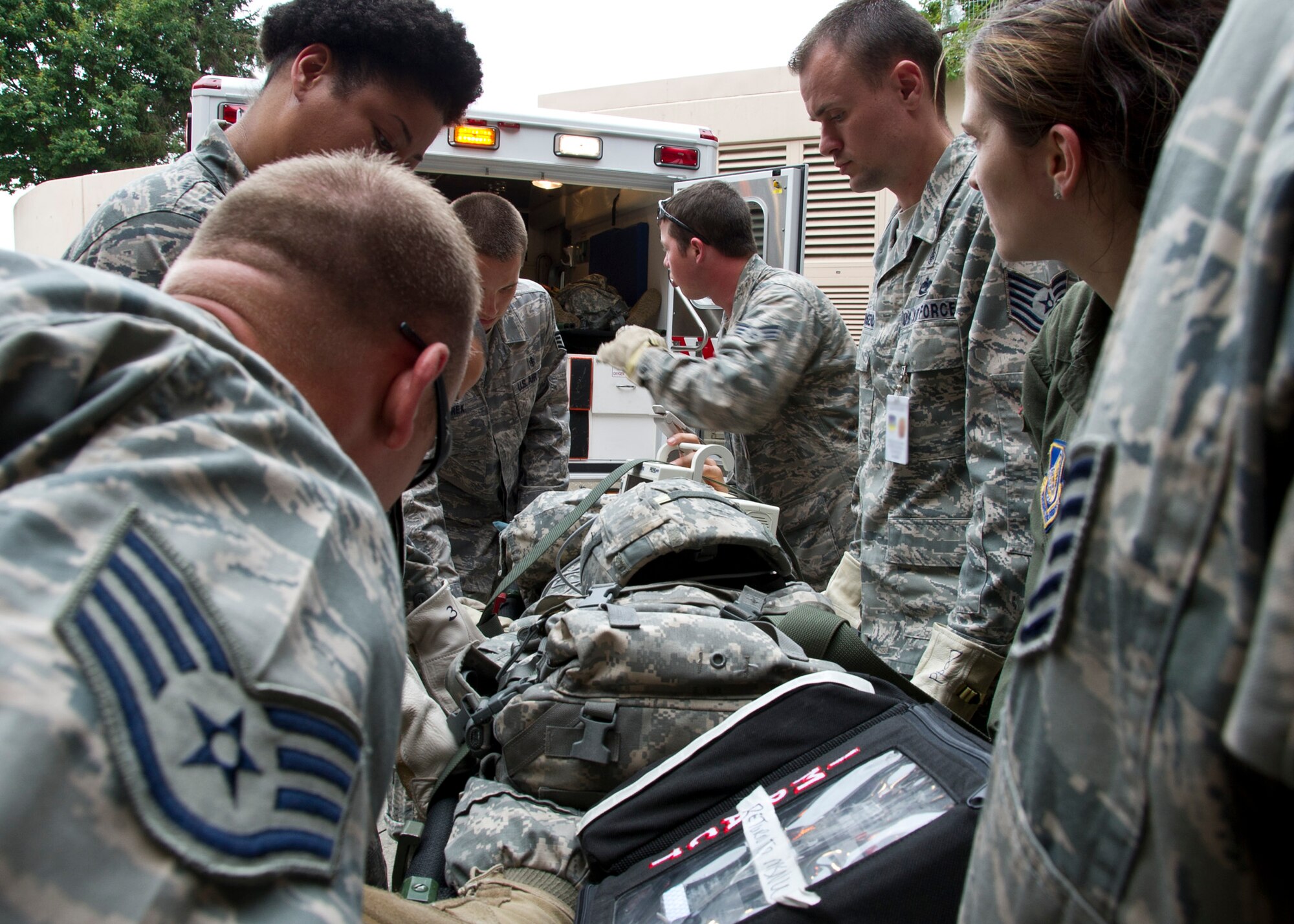 Airmen of the 51st Medical Group unload a patient from an ambulance during Dragon Lift, Aug. 24, 2011. During the exercise Airmen were graded on proper litter lifting techniques and proper litter movement commands to transport patients to and from the ambulance to the patient staging area. (U.S. Air Force photo/Senior Airman Adam Grant)
