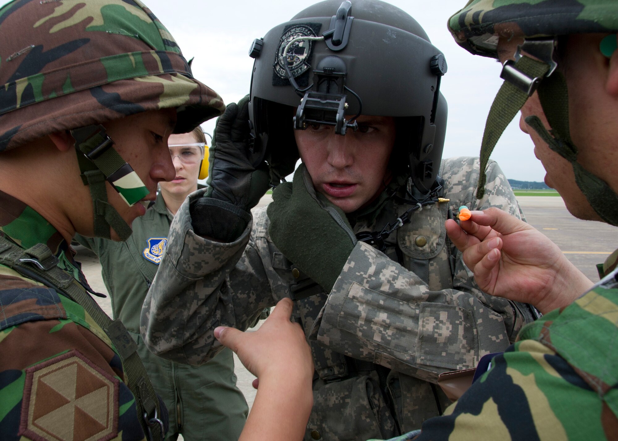 Staff Sgt. Justin Cauthen, Charlie Company 3rd General Support Aviation Battalion, 2nd Aviation Regiment, 2nd Combat Aviation Brigade, 2nd Infantry Division flight medic, talks with two Airmen from the Republic of Korea’s Air Force during Dragon Lift, Aug. 24, 2011. During Dragon Lift, Airmen were evaluated on properly “handing-off” patients with Air Evacuation Medical Crew, which includes patient reports, patient packaging for movement, equipment tracking and patient personal inventory and transfer. (U.S. Air Force photo/Senior Airman Adam Grant)