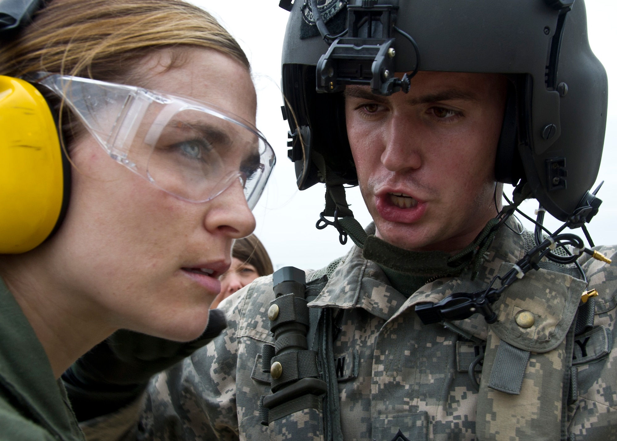 Capt. Angela Sullivan, 51st Medical Group flight surgeon, listens as Staff Sgt. Justin Cauthen, Charlie Company 3rd General Support Aviation Battalion, 2nd Aviation Regiment, 2nd Combat Aviation Brigade, 2nd Infantry Division flight medic, explains the number of patients aboard a UH-60 Black Hawk during Dragon Lift, Aug. 24, 2011. The exercise simulated coordinating medical evacuations by air. (U.S. Air Force photo/Senior Airman Adam Grant)