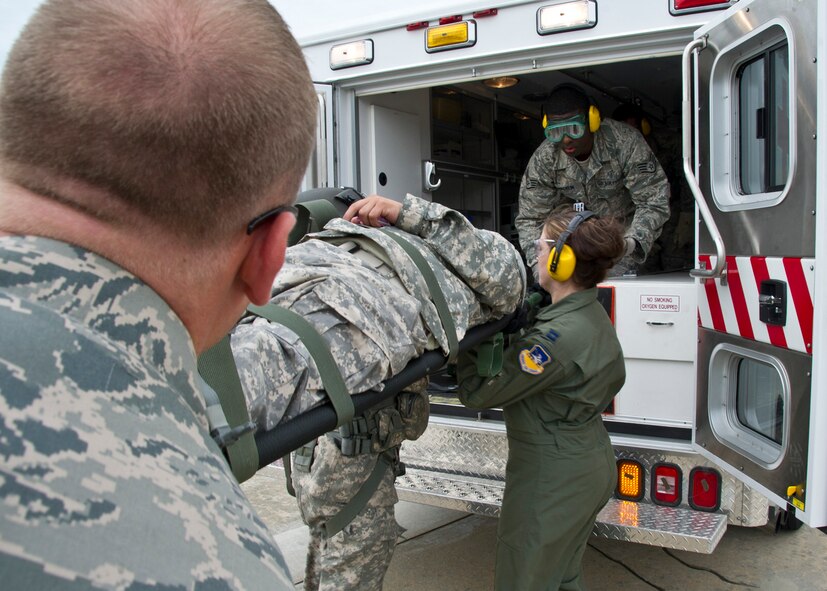 Members from the 51st Medical Group field response team transport a casualty from a UH-60 Black Hawk to an ambulance during Dragon Lift, Aug. 24, 2011. Afterward, the patient was transported to the patient staging area to be safely unloaded and treated. (U.S. Air Force photo/Senior Airman Adam Grant)