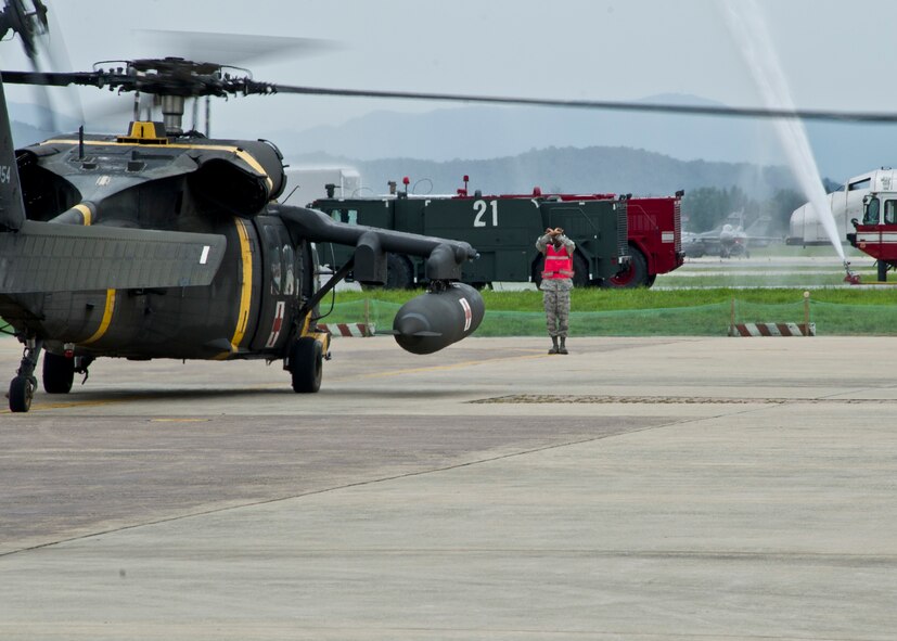 Airmen from the 51st Medical Group wait to unload patients from a UH-60 Black Hawk during Dragon Lift, Aug. 24, 2011. Charlie Company 3rd General Support Aviation Battalion and Republic of Korea’s Air Force participated in the one day exercise as well.  (U.S. Air Force photo/Senior Airman Adam Grant)