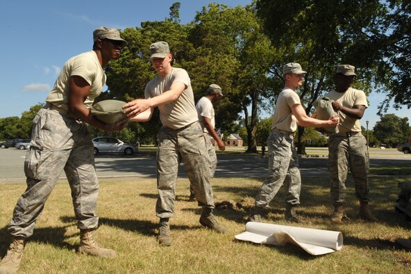 Airmen from the 633rd Communications Squadron move sandbags to the base telephone office to prevent flooding at Langley Air Force Base, Va., Aug. 25, 2011. Langley AFB is preparing for Hurricane Irene, which is expected to make landfall in the area on early Sunday morning. (U.S. Air Force photo by Staff Sgt. Logan Tuttle/released)