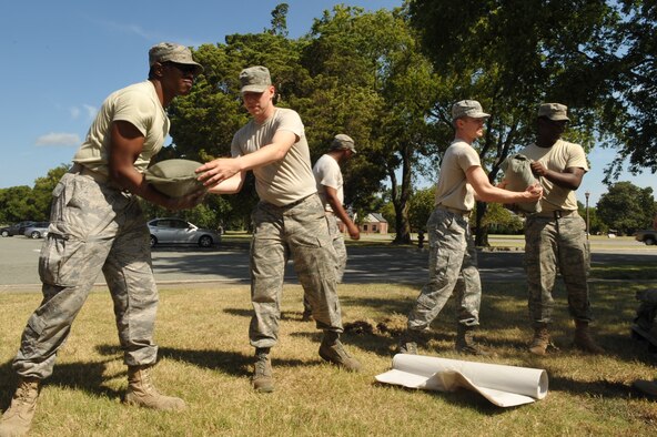 Airmen from the 633rd Communications Squadron move sandbags to the base telephone office to prevent flooding at Langley Air Force Base, Va., Aug. 25, 2011. Langley AFB was preparing for Hurricane Irene, which was expected to make landfall in the area. (U.S. Air Force photo/Staff Sgt. Logan Tuttle)