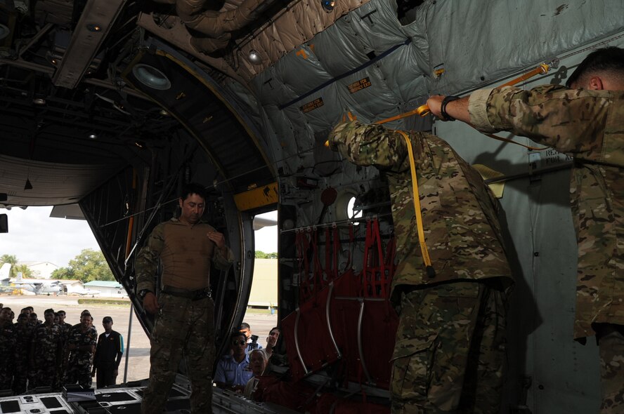 COLOMBO, Sri Lanka ? Jumpmaster, Master Sgt. John Gaona of the 18th Air Support Operations Group rehearses hand signals and jump commands with members of the Special Forces Group of the Sri Lanka Air Force while aboard a C-130 at Ratmalana Airport, Colombo, Sri Lanka on Aug. 23 during Pacific Airlift Rally 2011, a Pacific Air Force sponsored, biennial multilateral tactical military airlift symposium. The Special Forces Airmen will perform static line jumps from a U.S. Air Force C-130 as part of the exercise. Members from the Royal Australian Air Force (RAAF), the Sri Lanka Air Force, the Royal Malaysian Air Force and the U.S. Air Force are participating in the one-week exercise that enhances military airlift interoperability and cooperation between the nations of the Indo-Pacific region. (DoD photo/Master Sgt. Cohen A. Young)