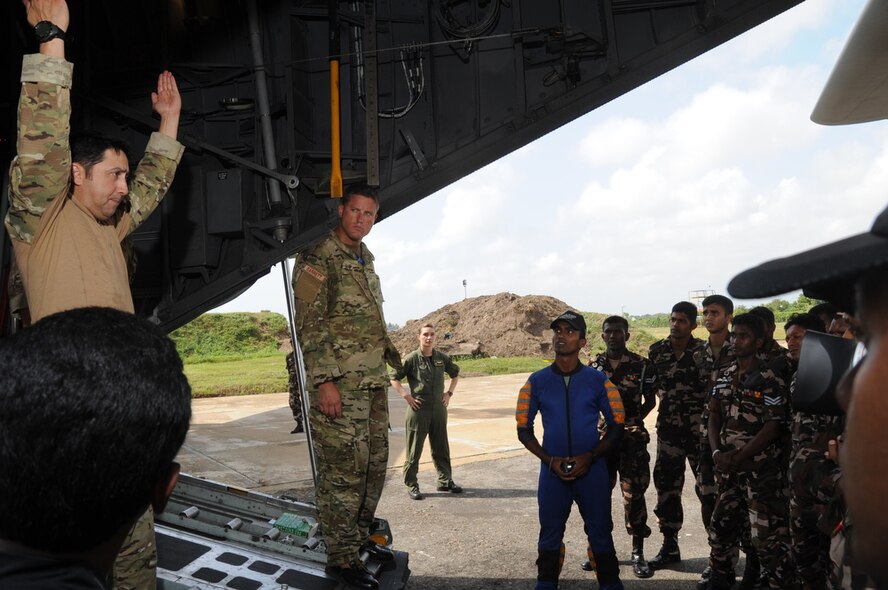 COLOMBO, Sri Lanka ? Jumpmaster, Master Sgt. John Gaona of the 18th Air Support Operations Group reviews hand signals and jump commands with Airmen from the Special Forces Group of the Sri Lanka Air Force while at Ratmalana Airport, Colombo, Sri Lanka on Aug. 23 during Pacific Airlift Rally 2011, a Pacific Air Force sponsored, biennial multilateral tactical military airlift symposium. The special forces Airmen will perform static line jumps from a U.S. Air Force C-130 as part of the exercise. Members from the Royal Australian Air Force (RAAF), the Sri Lanka Air Force, the Royal Malaysian Air Force and the U.S. Air Force are participating in the one-week exercise that enhances military airlift interoperability and cooperation between the nations of the Indo-Pacific region. (DoD photo/Master Sgt. Cohen A. Young)