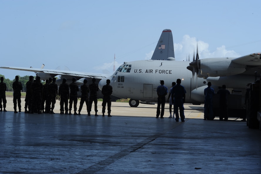 COLOMBO, Sri Lanka - Sri Lanka Air Force maintenance and aircrew watch as a 36th Expeditionary Squadron C-130 from Yokota Air Base, Japan passes by them as it prepares to takeoff on an airlift mission at Ratmalana Airport, Colombo, Sri Lanka on Aug. 23 during Pacific Airlift Rally 2011, a Pacific Air Force sponsored, biennial multilateral tactical military airlift symposium. Members from the Royal Australian Air Force (RAAF), the Sri Lanka Air Force, the Royal Malaysian Air Force and the U.S. Air Force are participating in the one-week exercise that enhances military airlift interoperability and cooperation between the nations of the Indo-Pacific region. (DoD photo/Master Sgt. Cohen A. Young)