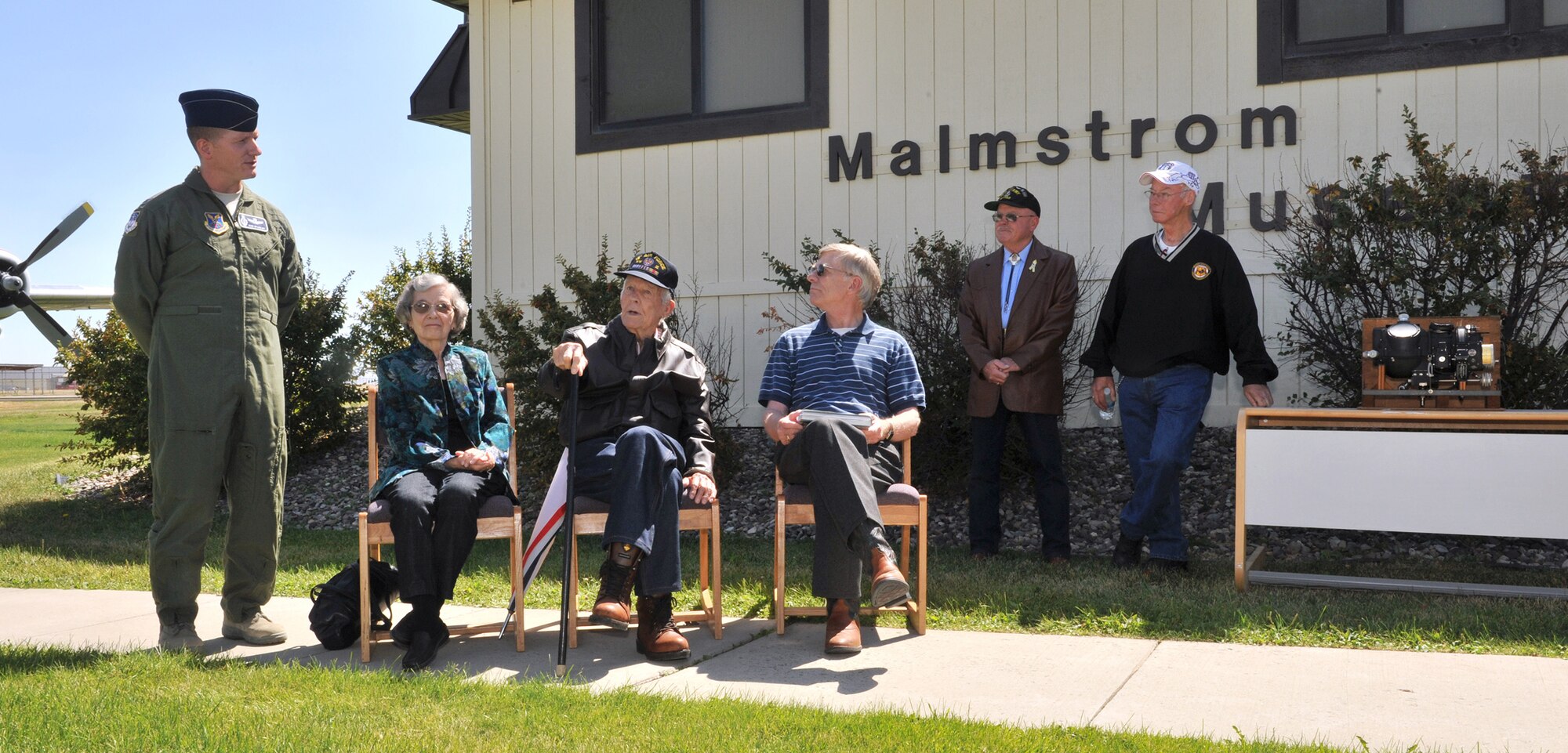 Col. Robert Stanley, 341st Missile Wing vice commander, and Jack Gamble, World War II arial gunner, sitting center, reflect on the importance of the Norden Bombsight during World War II. Sitting with Gamble are his wife, Ginny, and son, Jim. Standing in the background are Bill Selling and his borther Mike Hanlen, who donated the bombsight in memory of their father. It will be publicly exhibited in the spring of 2012.