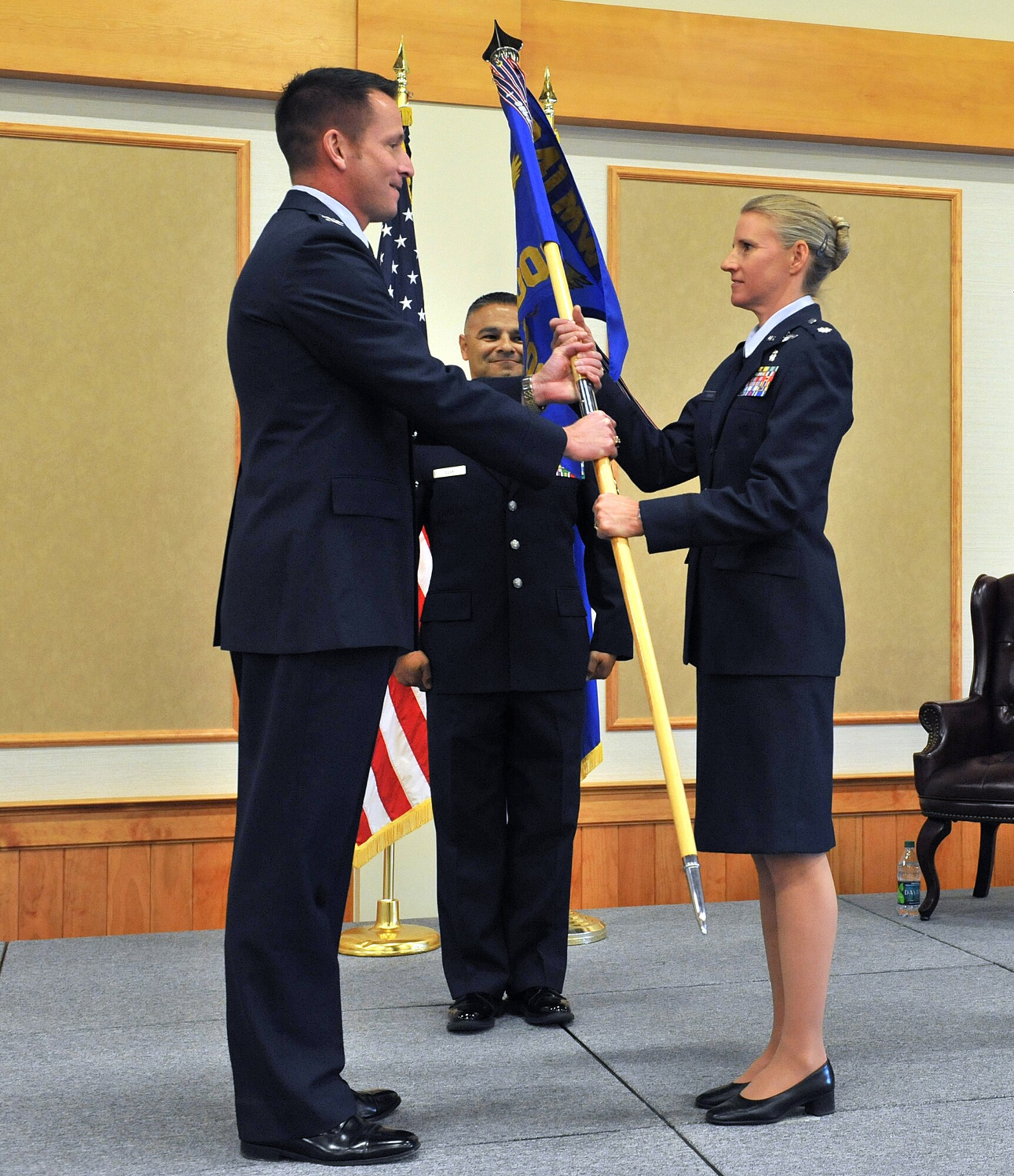 Lt. Col Karee Jensen accepts command of the 341st Medical Operations Squadron from Col. R. Bruce Roehm, 341st Medical Group Commander Aug. 19 at the Grizzly Bend. Master Sergeant Timoteo Silva, 341st MDG first ssergeant, looks on.