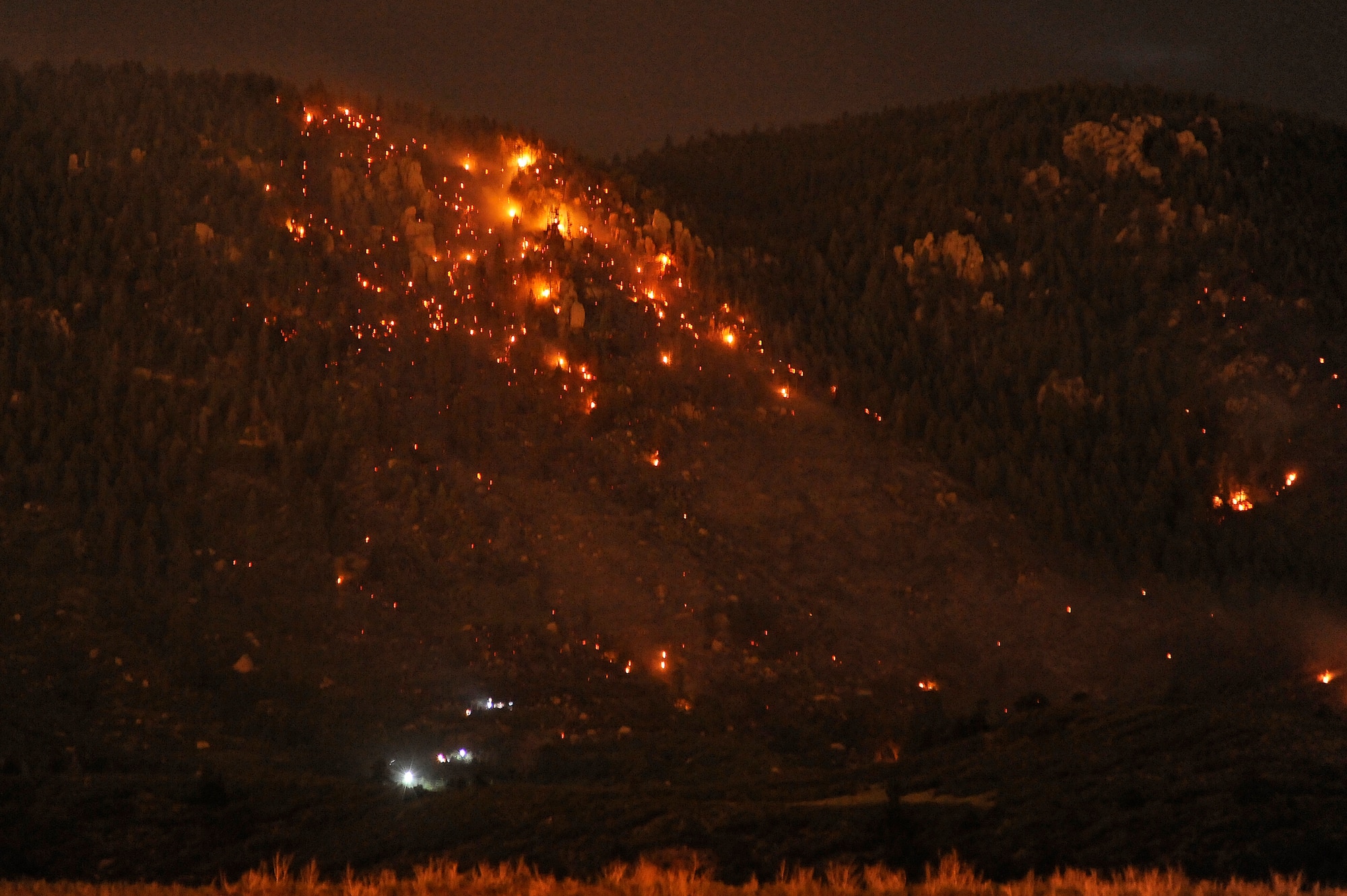 Hotspots burn along the ridges of the Rocky Mountain Front Range in the evening hours of Aug. 19, 2011, north of the Air Force Academy. Firefighters from the Academy and the Tri-Lakes Fire Department who helped contain the blaze Aug. 19-21 got help from the weather, which extinsuighed the fire after it burned about 100 acres. (U.S. Air Force photo/Mike Kaplan)