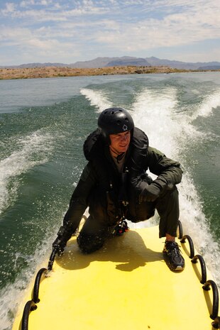 U.S. Air Force Maj. Jeff Cannon, 57th Weapons Support Squadron, F-15E Strike Eagle pilot, Nellis Air Force Base, Nev., is towed back to shore behind a personal watercraft after completing water survival training at Lake Mead, Nev. Aug. 17, 2011. SERE specialists train aircrew members how to survive and evade capture if they eject, bailout or otherwise become isolated during combat situations. (U.S. Air Force photo by Staff Sgt. Taylor Worley/Released)
