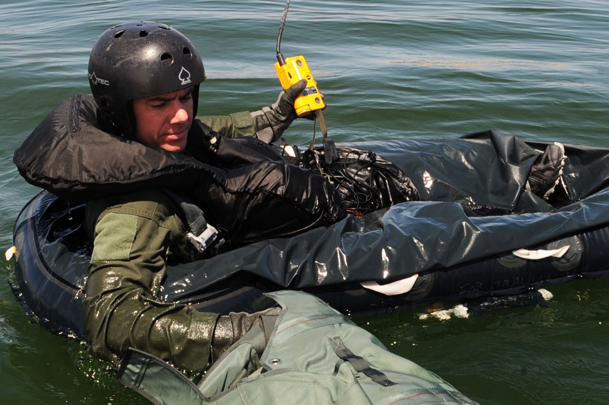 U.S. Air Force Maj. Jeff Cannon, 57th Weapons Support Squadron, F-15E Strike Eagle pilot, floats in a one man life raft while participating in water survival training with the 57th Operation Support Squadron Survival, Evasion, Resistance and Escape Specialists at Lake Mead, Nev. Aug. 17, 2011. SERE specialists train high risk aircrew personnel to survive, evade, and return should they eject, bailout, or otherwise become isolated during combat, anywhere in the world. (U.S. Air Force photo by Staff Sgt. Taylor Worley/Released)
