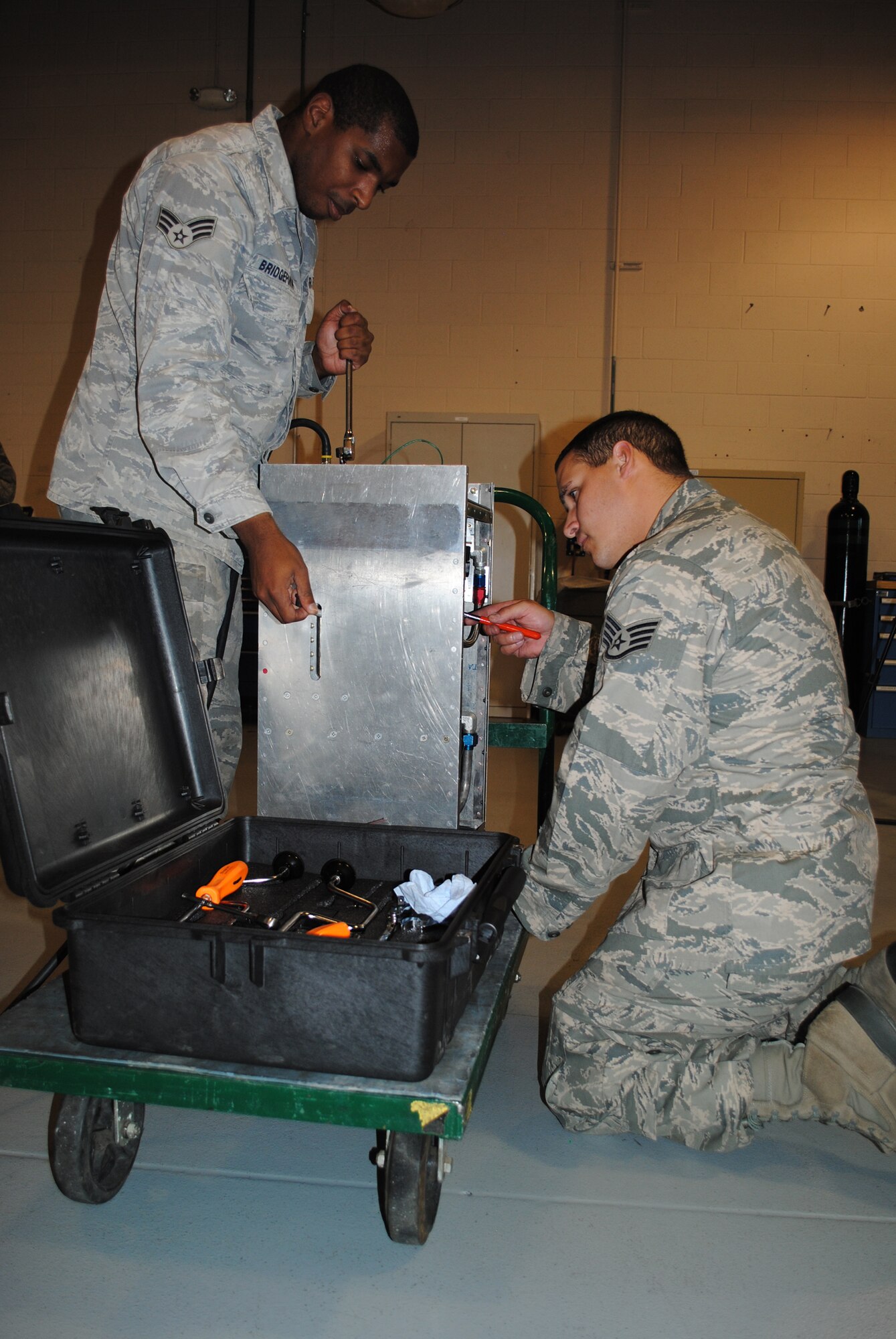Senior Airman Tyrell Bridgeforth and Staff Sgt. Robert Jovin work on testing a relief valve in preparation for the upcoming Global Strike Challenge.