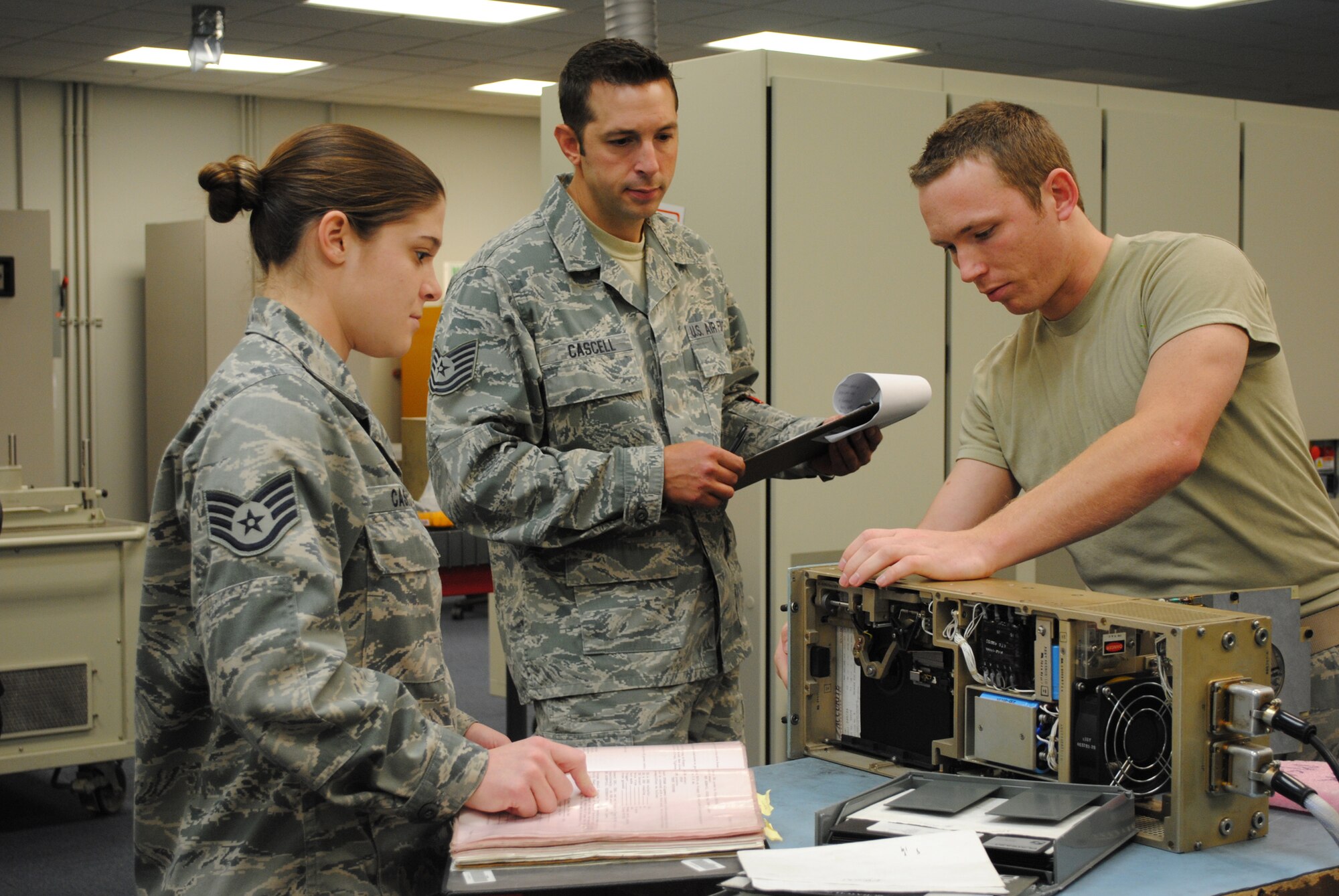 The Global Strike Challenge Electronics Laboratory team works on trouble shooting with a floppy disk drive.