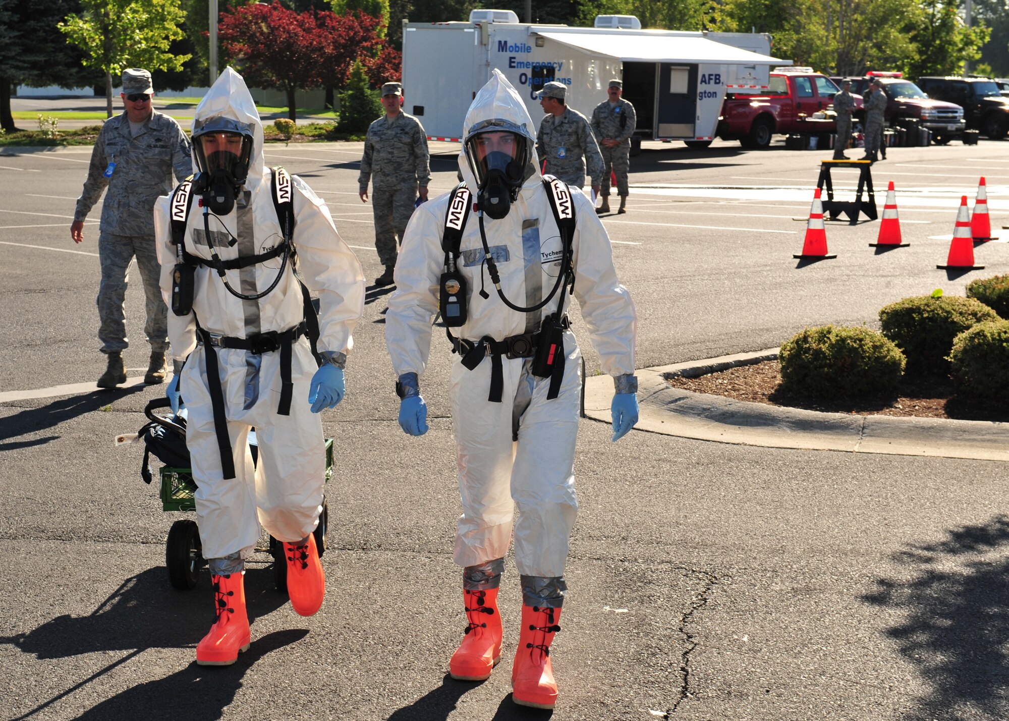 Airman 1st Class Francisco Sanchez and Senior Airman Jeffrey Gomez, 92nd Aerospace Medicine Squadron Bioenvironmental technicians, respond to the education center during the exercise Aug. 17. (U.S. Air Force photo/Staff Sgt. Michael Means)