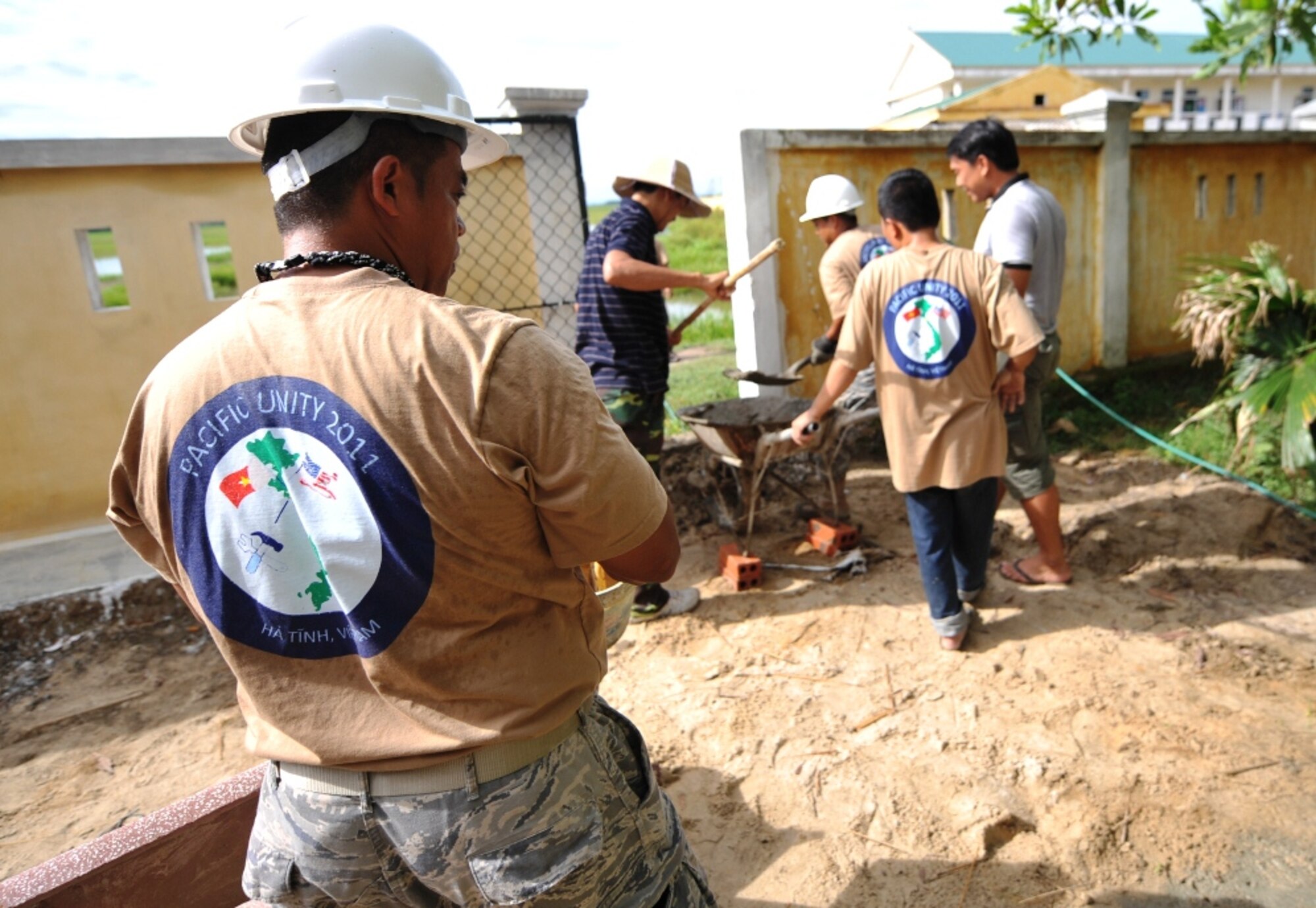 U.S. Air Force Reserve Technical Sergeant Elmer Domingo, crew member of the 624th Civil Engineer Squadron, Joint Base Pearl Harbor-Hickam, Hawaii, works with Vietnamese military members to make improvements to Thach Dong medical clinic in Ha Tinh Province, Vietnam on August 18th, 2011 in support of Engineering Civic Action Program (ENCAP) Pacific Unity 11-4.  The operation includes more than 60 U.S. and Vietnamese service members, contractors and support personnel, and showcases the potential of total force integration and multinational interoperability.  (U.S. Air Force image/Master Sgt. John Herrick)