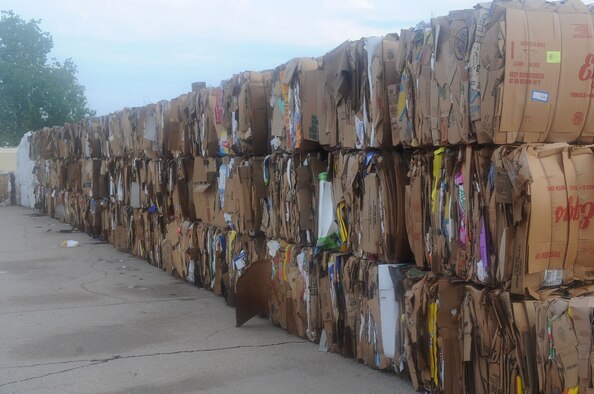 Compacted cardboard boxes are stacked in bundles awaiting pick-up behind the Commissary on Barksdale Air Force Base, La., Aug. 25. Each bundle weighs about one ton. They are recycled and used to make new cardboard boxes and other paper products. (U.S. Air Force photo/Senior Airman Kristin High)(RELEASED)