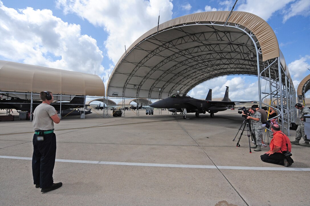 An F-15E Strike Eagle crew chief marshals an aircraft to be launched for the evacuation of incoming Hurricane Irene here, Aug. 25, 2011. Wing maintainers worked long hours around the clock to ensure dozens of aircraft were mission capable for the launch. Aircraft remaining on the base will be moved to enclosed hangars for protection from the elements. (U.S. Air Force photo by Senior Airman Rae Perry/Released)