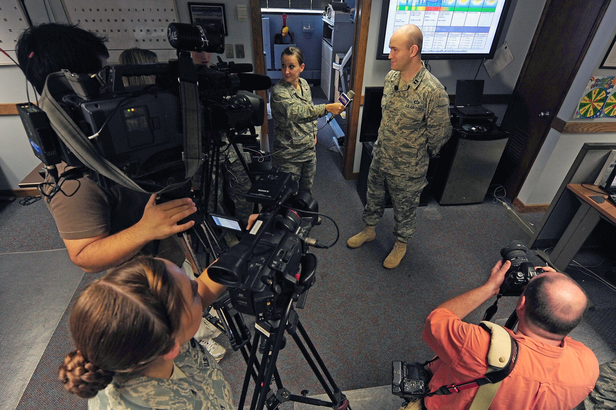 Captain Ryan Rickert answers questions about incoming Hurricane Irene during an interview by local news agencies in the weather office here, Aug. 25, 2011. The 4th Operations Support Squadron weather flight helped commanders of both the 4th Fighter Wing and 916th Air Refueling Wing make informed decisions about relocating approximately 70 aircraft from the hurricane's path. Rickert, 4th OSS weather flight commander, hails from Easton, Pa. (U.S. Air Force photo by Senior Airman Rae Perry/Released)