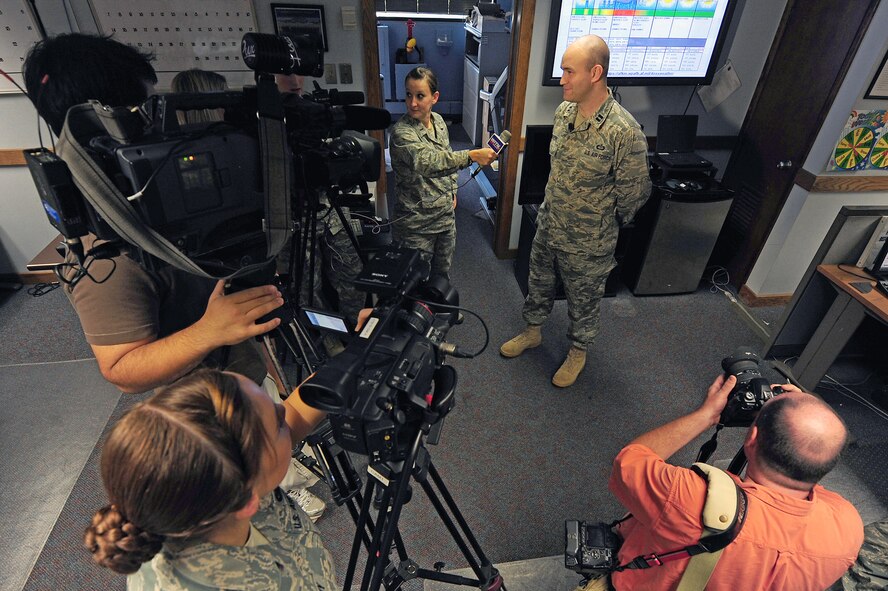 Captain Ryan Rickert answers questions about incoming Hurricane Irene during an interview by local news agencies in the weather office here, Aug. 25, 2011. The 4th Operations Support Squadron weather flight helped commanders of both the 4th Fighter Wing and 916th Air Refueling Wing make informed decisions about relocating approximately 70 aircraft from the hurricane's path. Rickert, 4th OSS weather flight commander, hails from Easton, Pa. (U.S. Air Force photo by Senior Airman Rae Perry/Released)