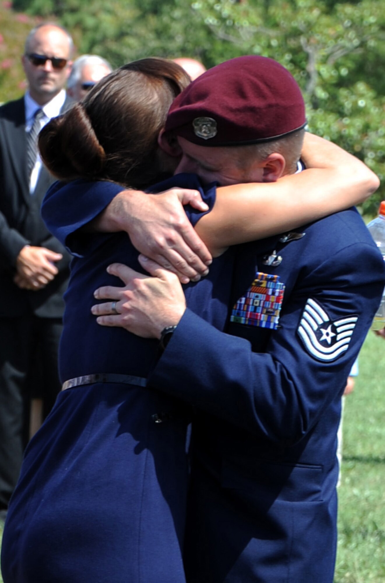ARLINGTON NATIONAL CEMETERY, Va. -- Amanda Harke, Tech. Sgt. Daniel B. Zerbe's girlfriend, embraces one of Zerbe's teammates during a funeral service held in honor of Zerbe here Aug. 23, 2011. Zerbe was killed when a CH-47 Chinook carrying troops, crashed in the Maiden Wardak Province in eastern Afghanistan. (U.S. Air Force photo/Staff Sgt. Tiffany Trojca)