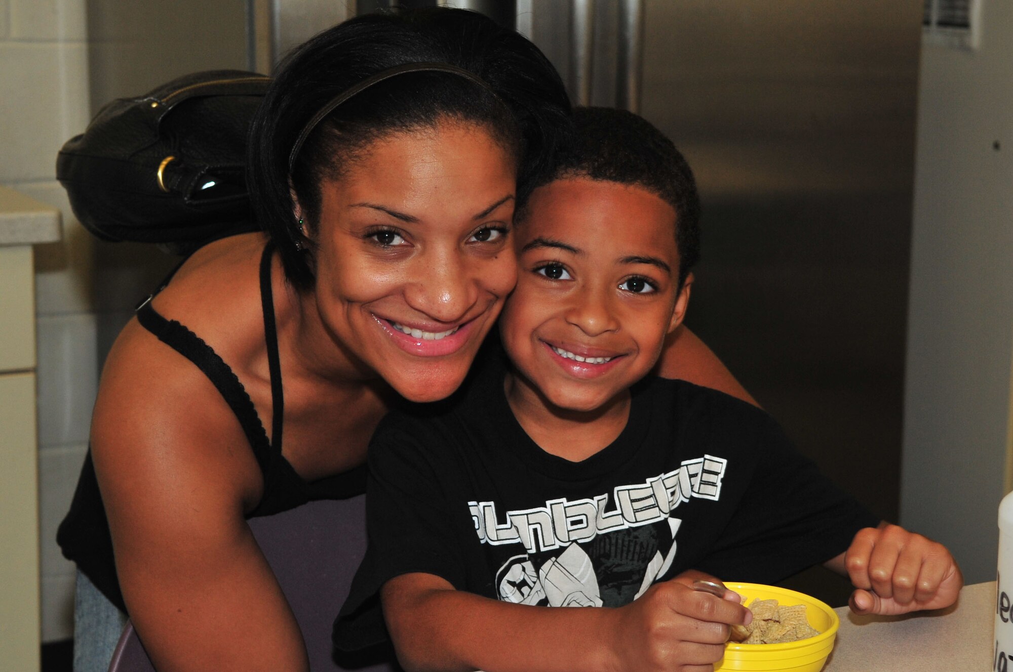 SEYMOUR JOHNSON AIR FORCE BASE, N.C. - Shauna McBrayer and son, Joshua McBrayer, 6, have breakfast at the youth center before Joshua begins his first day of kindergarten, at Meadow Lane Elementary school in Goldsboro, Aug 25, 2011. The youth center here has a program in which military children can come, have breakfast before school and board a school bus to either Greenwood Middle School or Meadow Lane Elementary School. Costs are determined by family income. Joshua is the son of Staff Sgt. Brandon McBrayer, weapons load crew member at the 334th Aircraft Maintenance Unit. (U.S. Air Force Photo by Senior Airman Marissa Tucker)(RELEASED)