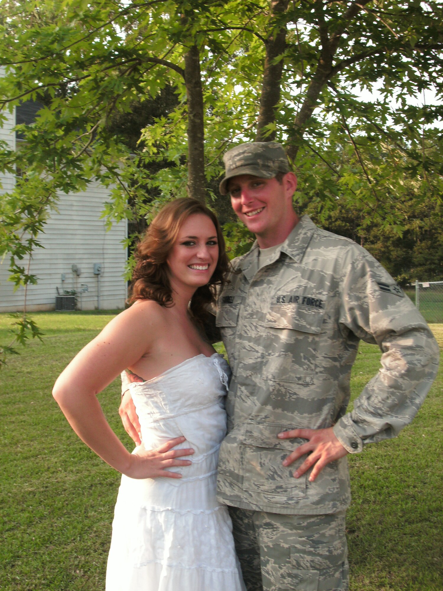 Amanda Walker and Airman 1st Class Christopher Farrell, a 54th Combat Communications Squadron ground radar systems journeyman at Robins Air Force Base, Ga., embrace in front of her family home in Euharlee, Ga. The couple recently won an essay contest that bumped their wedding plans up to a grand-scale, $70 thousand wedding. The couple will wed Nov. 19. (Courtesy photo by Tiffani Walker)