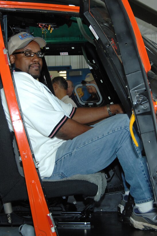 Freddie Winston, who owns a construction company near Washington D.C., sits in a HH-65 Dolphin helicopter at U.S. Coast Guard Air Station Detroit, located on Selfridge Air National Guard Base, Mich., Aug. 25, 2012. Winston was participating in a Boss-Lift program in which civilian employers are given an orientation tour of a military base to help educate them on the duties of their employees who also serve in the National Guard or one of the Reserve components of the military. The trip was organized by the Employer Support of the Guard and Reserve organization. (USAF photo by Rachel Barton)