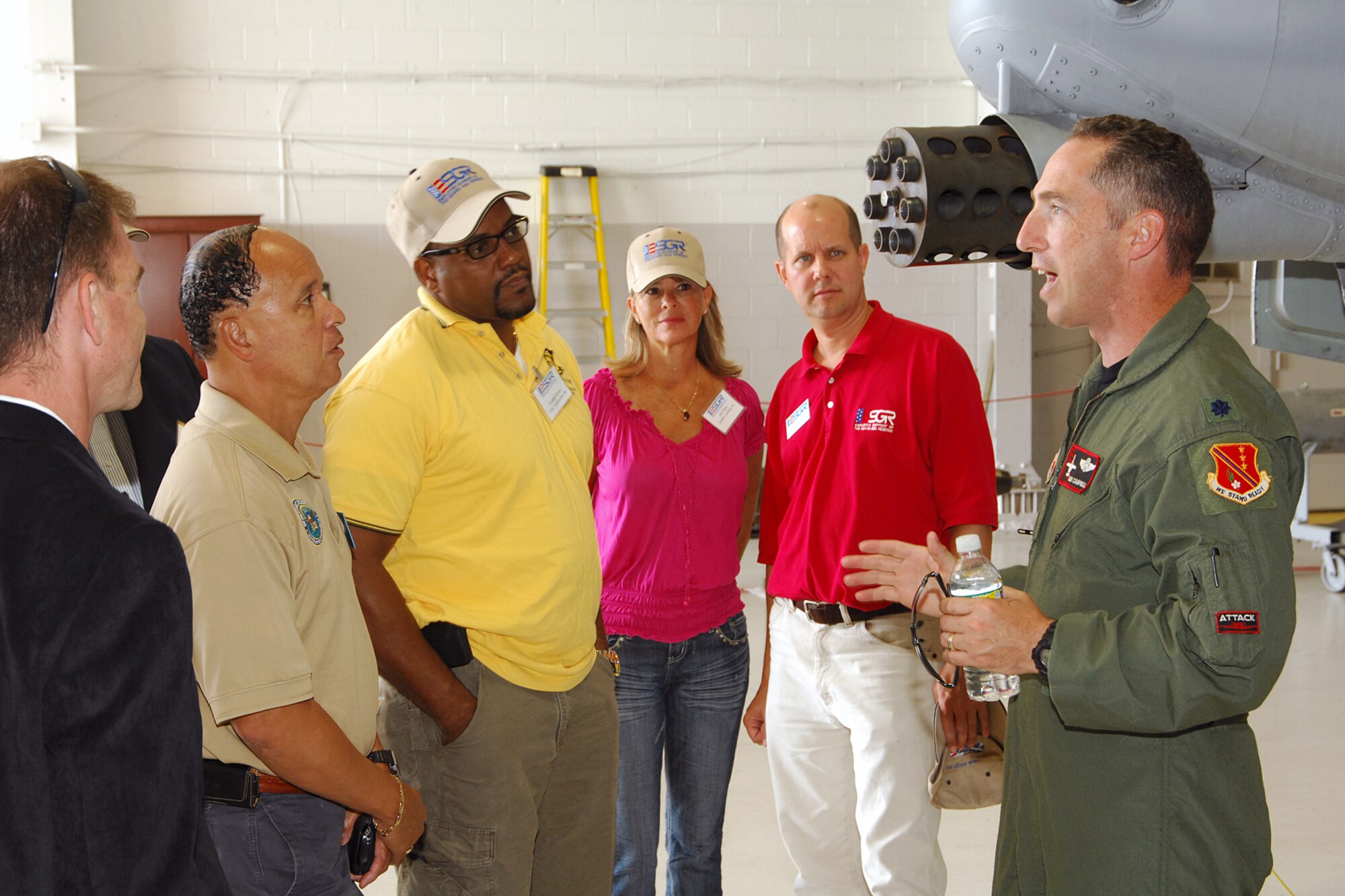 Lt. Col. Sean Campbell, a pilot with the 107th Fighter Sqaudron, explains the capabilities of an A-10 Thunderbolt II aircraft to a group of visiting civilian employers at Selfridge Air National Guard Base, Mich., Aug. 24, 2011. The employers are from the Washington, D.C. area. The trip to Selfridge was organized by the Employer Support of the Guard and Reserve organization to help educate employers about the Guard and Reserve forces. Campbell is standing next to the GAU-8/A 30 mm Gatling gun, the primary weapon of the A-10. (USAF photo by John S. Swanson)