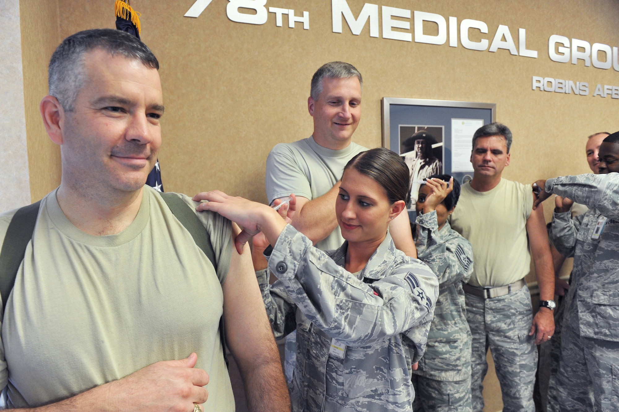 Front to back, Col. Mitchel Butikofer, 78th Air Base Wing commander; Col. Evan Miller, 402nd Maintenance Wing commander; Col. David Southerland, 78th Air Base vice  commander, and Chief Patrick Bowen, 78th ABW and WR-ALC Command Chief, get their flu shots from Airman 1st Class Christina Timberlake, Tech. Sgt. Tamiko Penn and  Senior Airman Jarred Taylor. U. S. Air Force photo by Tommie Horton